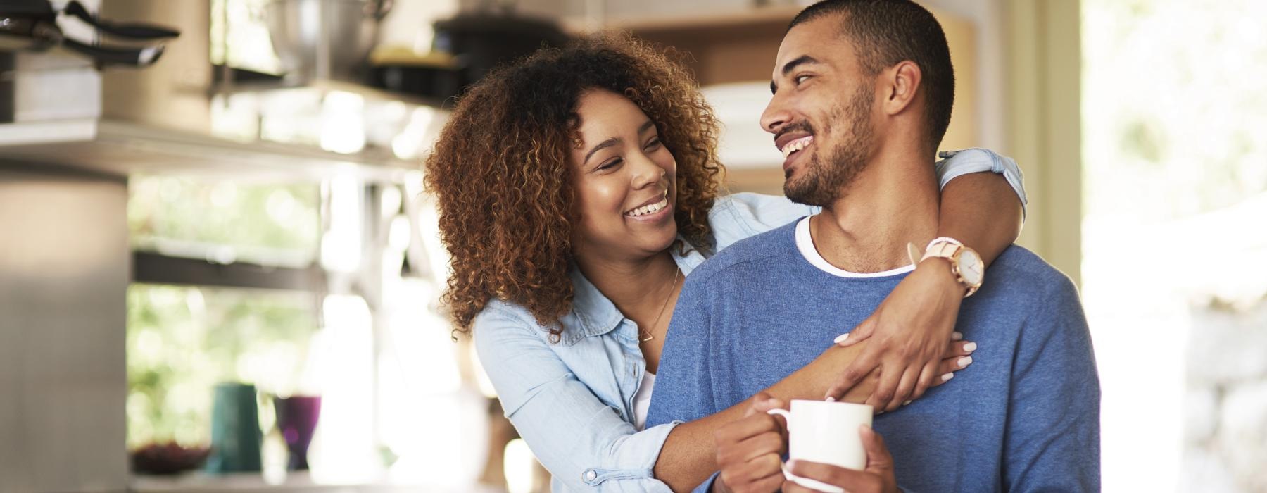 a man and a woman holding coffee cups