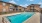 a swimming pool in front of a brick building