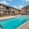 a swimming pool in front of a brick building